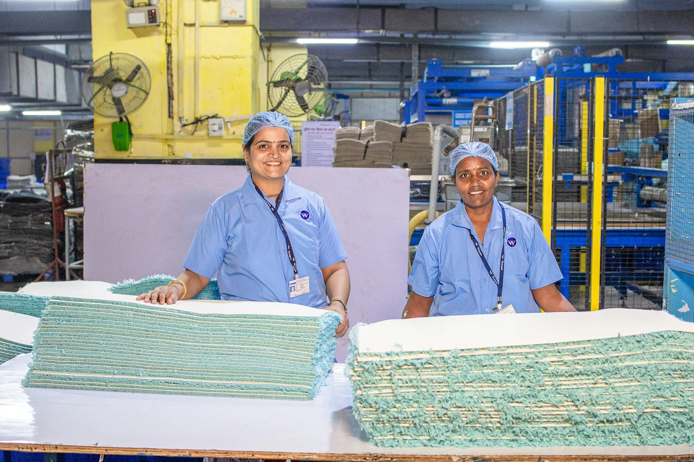Two production workers smiling in a factory